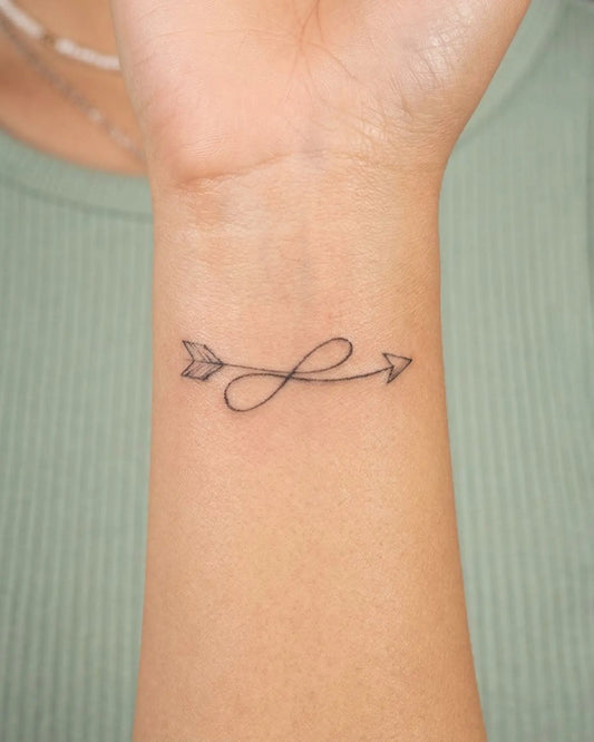 INKY Loop Arrow semi-permanent tattoo applied on a woman – 2 x 2 in (4x4 cm) design, realistic ink look, lasts 10 days