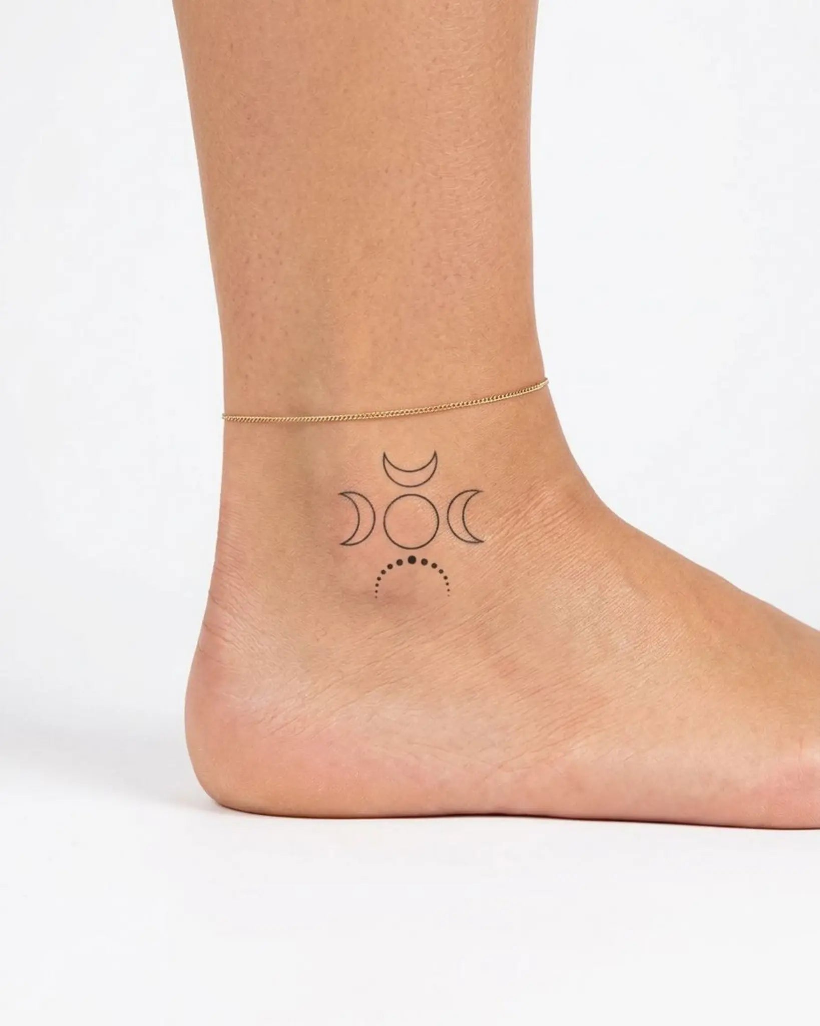 INKY Triple Moon semi-permanent tattoo applied on a woman – 2 x 2 in (4x4 cm) design, realistic ink look, lasts 10 days