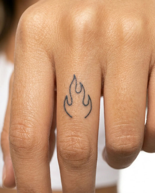 INKY Flame Outline semi-permanent tattoo applied on a woman – 0.5 x 0.5 in (1x1 cm) design, realistic ink look, lasts 10 days