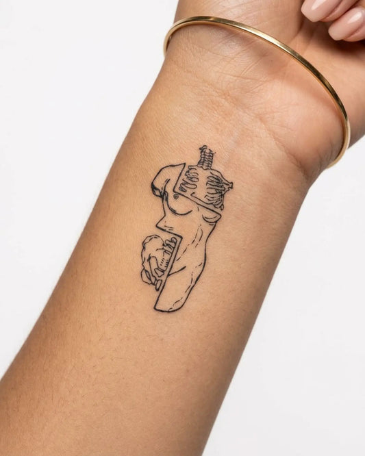 INKY Fragmented semi-permanent tattoo applied on a woman – 2 x 4 in (6x10 cm) design, realistic ink look, lasts 10 days