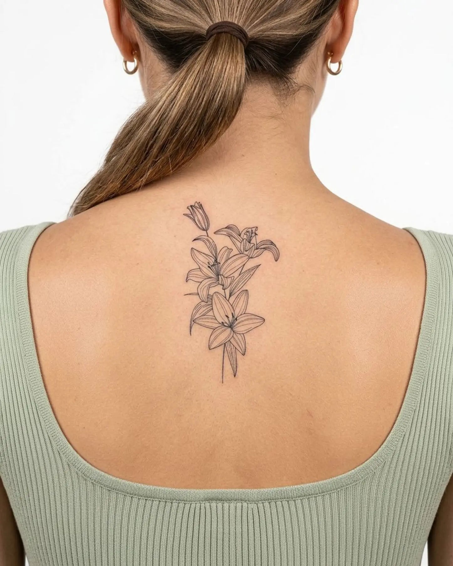 INKY Lily Bloom semi-permanent tattoo applied on a woman – 2 x 4 in (6x10 cm) design, realistic ink look, lasts 10 days