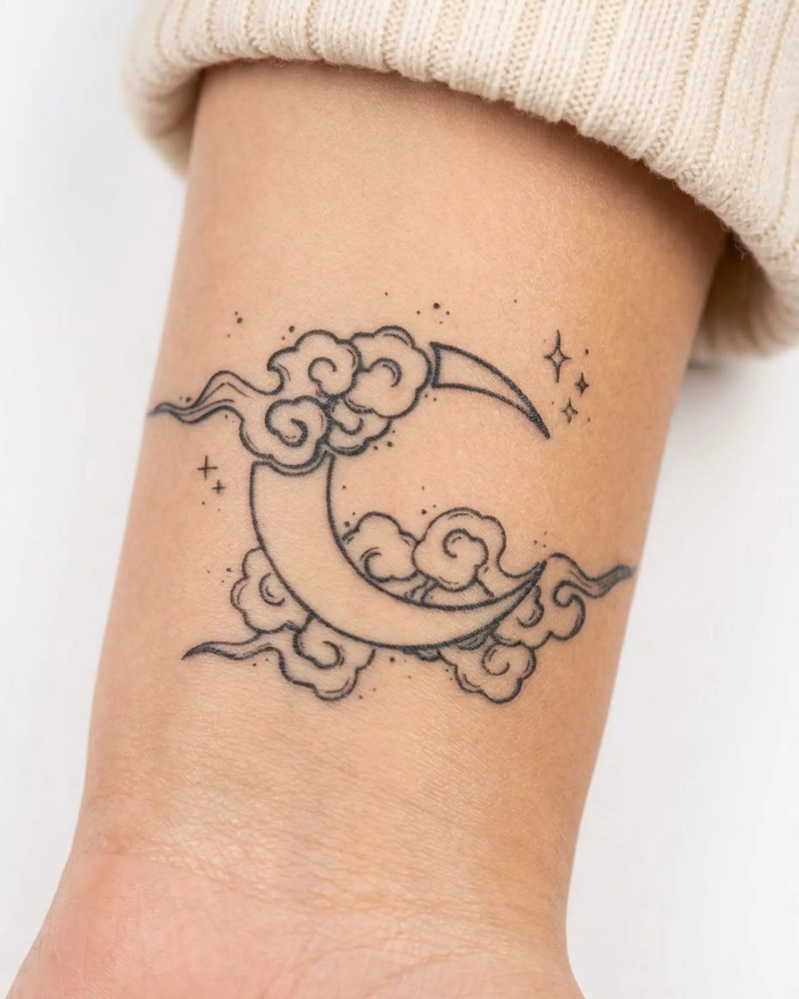 INKY Cloud Moon semi-permanent tattoo applied on a woman – 2 x 2 in (4x4 cm) design, realistic ink look, lasts 10 days