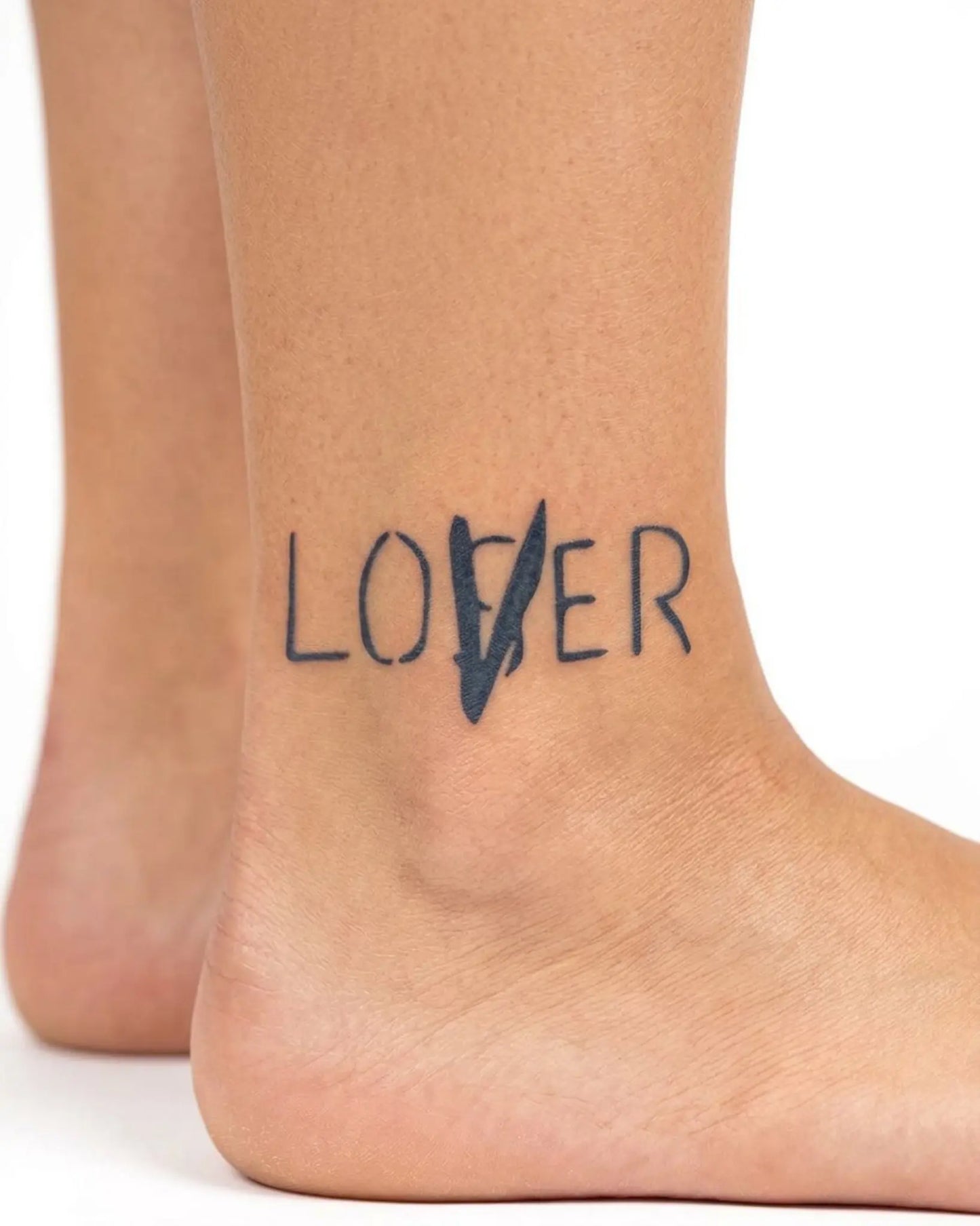 INKY Lover/Loser semi-permanent tattoo applied on a woman – 2 x 2 in (4x4 cm) design, realistic ink look, lasts 10 days