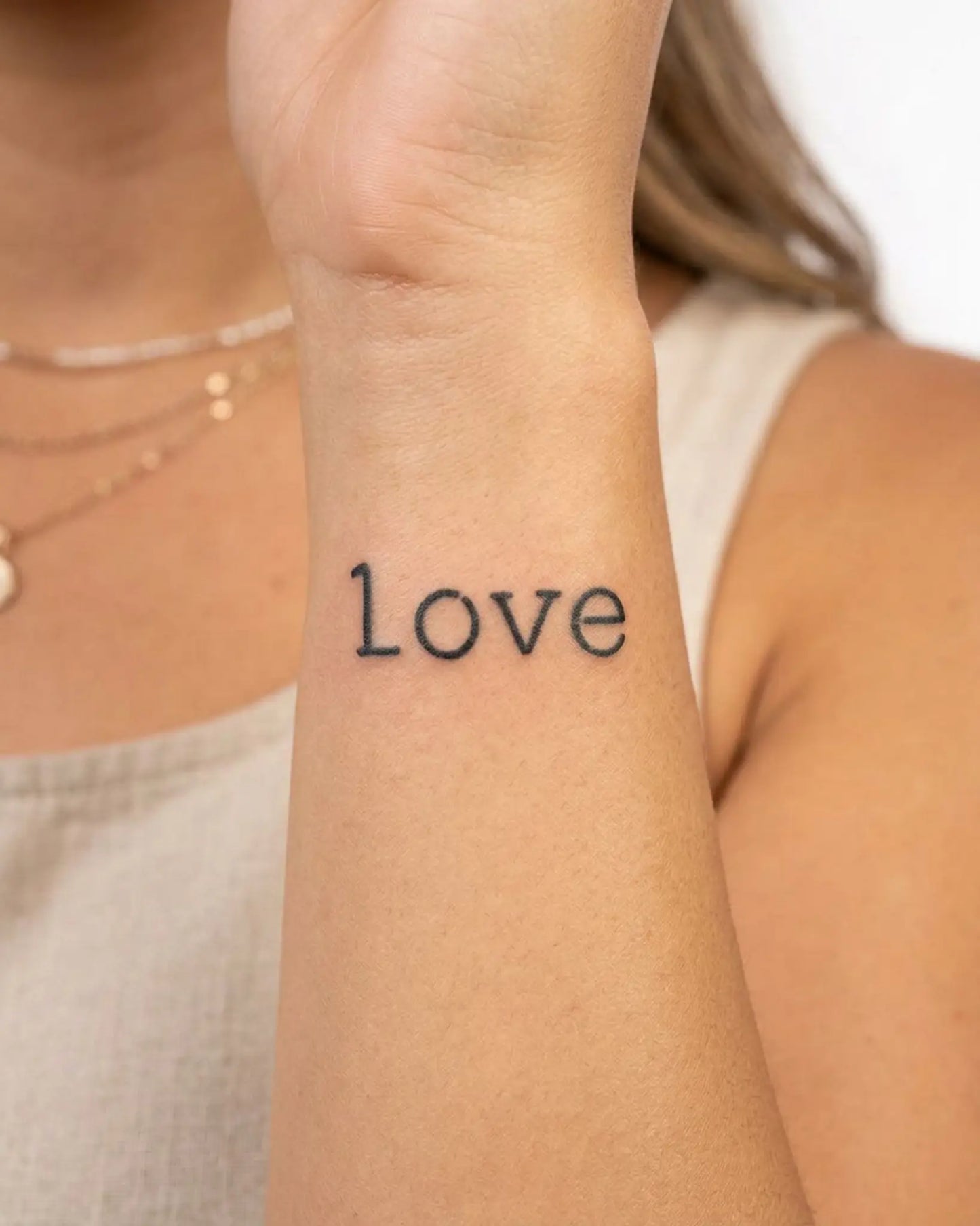 INKY Love semi-permanent tattoo applied on a woman – 2 x 2 in (4x4 cm) design, realistic ink look, lasts 10 days