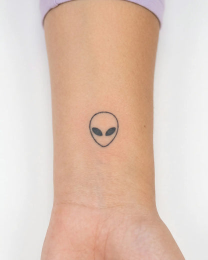 INKY Alien Head semi-permanent tattoo applied on a woman – 0.5 x 0.5 in (1x1 cm) design, realistic ink look, lasts 10 days