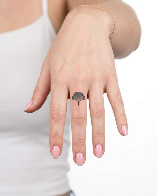 INKY Ginkgo Leaf semi-permanent tattoo applied on a woman – 0.5 x 0.5 in (1x1 cm) design, realistic ink look, lasts 10 days