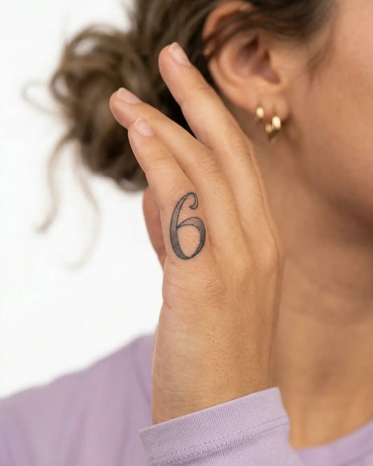 INKY Lucky Six semi-permanent tattoo applied on a woman – 0.5 x 0.5 in (1x1 cm) design, realistic ink look, lasts 10 days