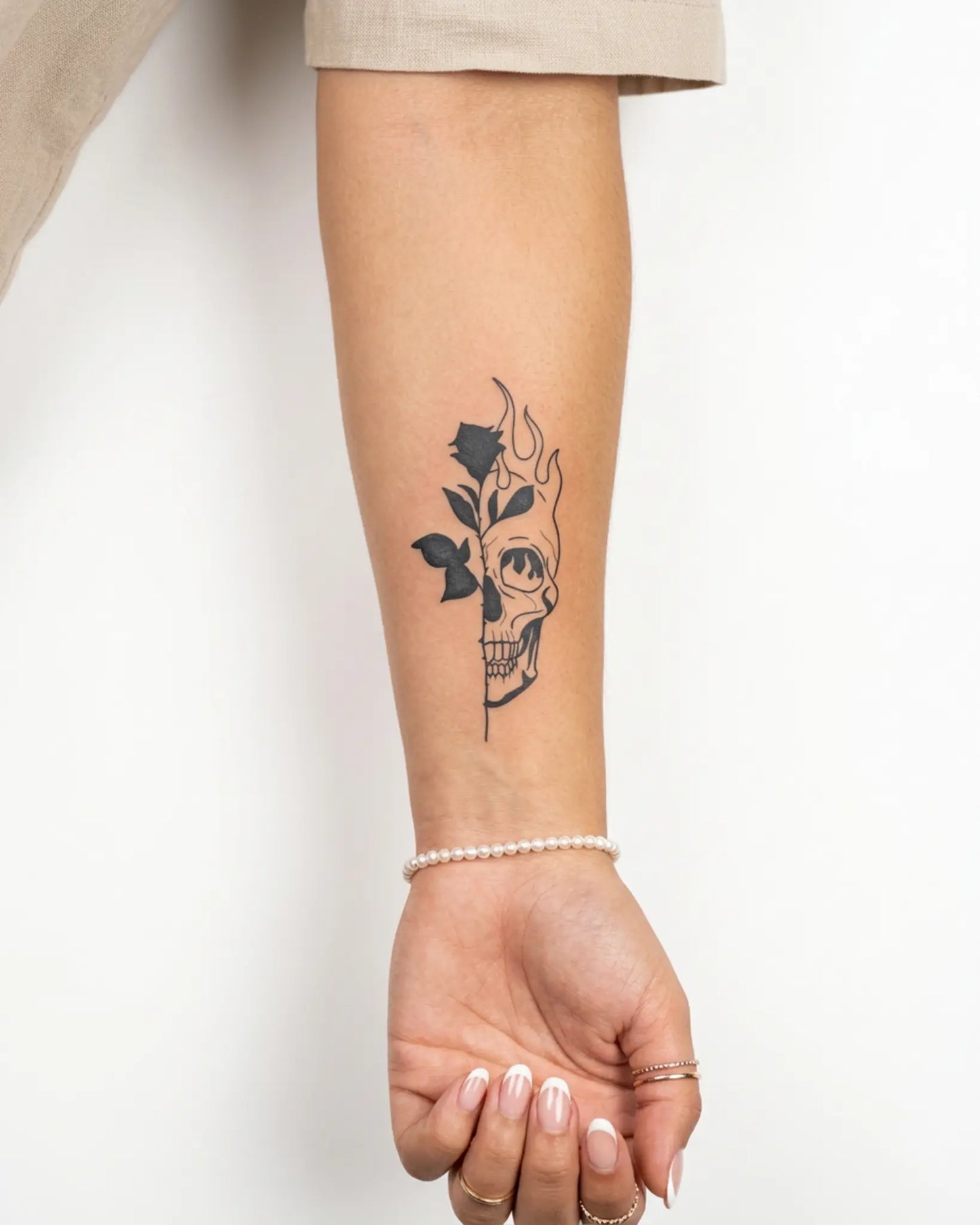INKY Skull Bloom 3 semi-permanent tattoo applied on a woman – 2 x 4 in (6x10 cm) design, realistic ink look, lasts 10 days
