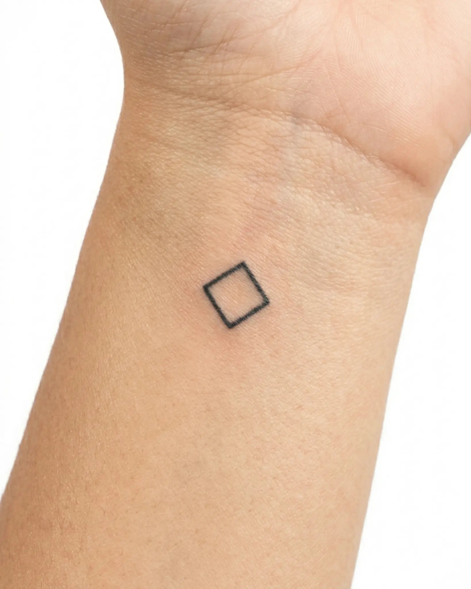 INKY Geo Diamond semi-permanent tattoo applied on a woman – 0.5 x 0.5 in (1x1 cm) design, realistic ink look, lasts 10 days
