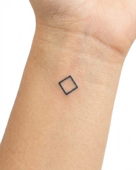 INKY Geo Diamond semi-permanent tattoo applied on a woman – 0.5 x 0.5 in (1x1 cm) design, realistic ink look, lasts 10 days