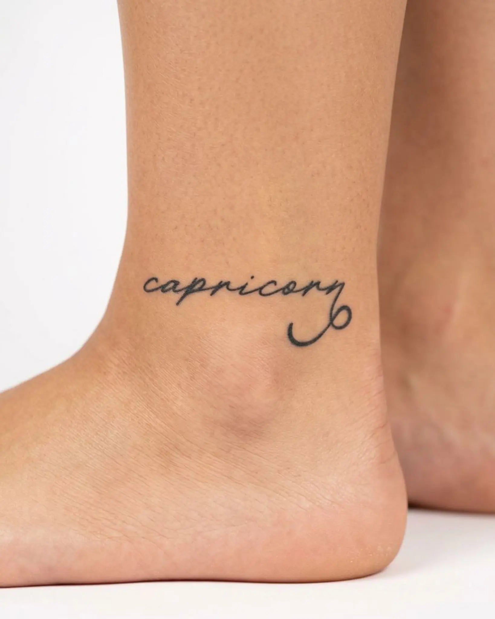 INKY Capricorn semi-permanent tattoo applied on a woman – 2 x 2 in (4x4 cm) design, realistic ink look, lasts 10 days