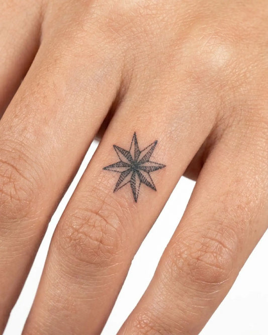 INKY North Star semi-permanent tattoo applied on a woman – 0.5 x 0.5 in (1x1 cm) design, realistic ink look, lasts 10 days