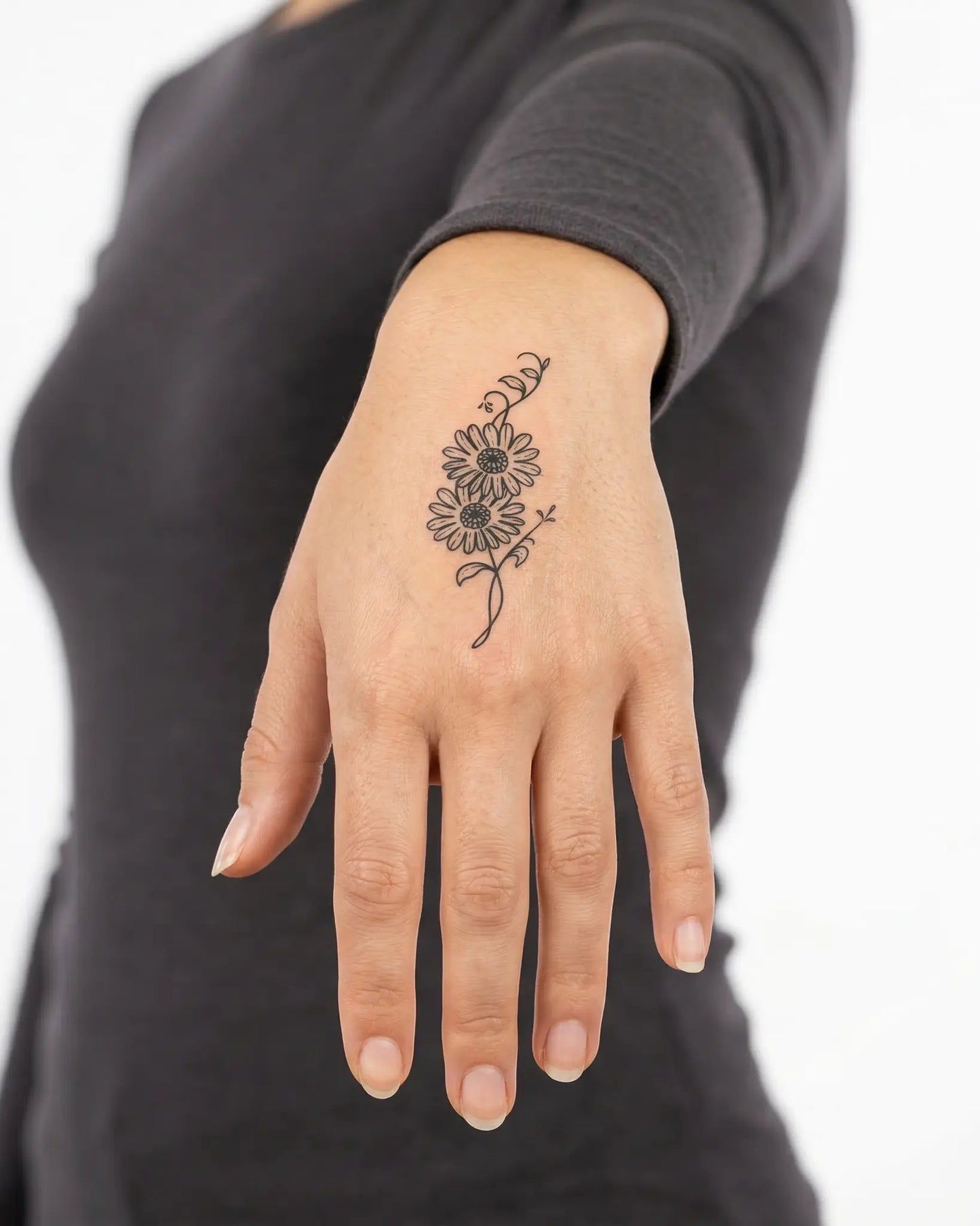 INKY Daisy Duet semi-permanent tattoo applied on a woman – 2 x 2 in (4x4 cm) design, realistic ink look, lasts 10 days