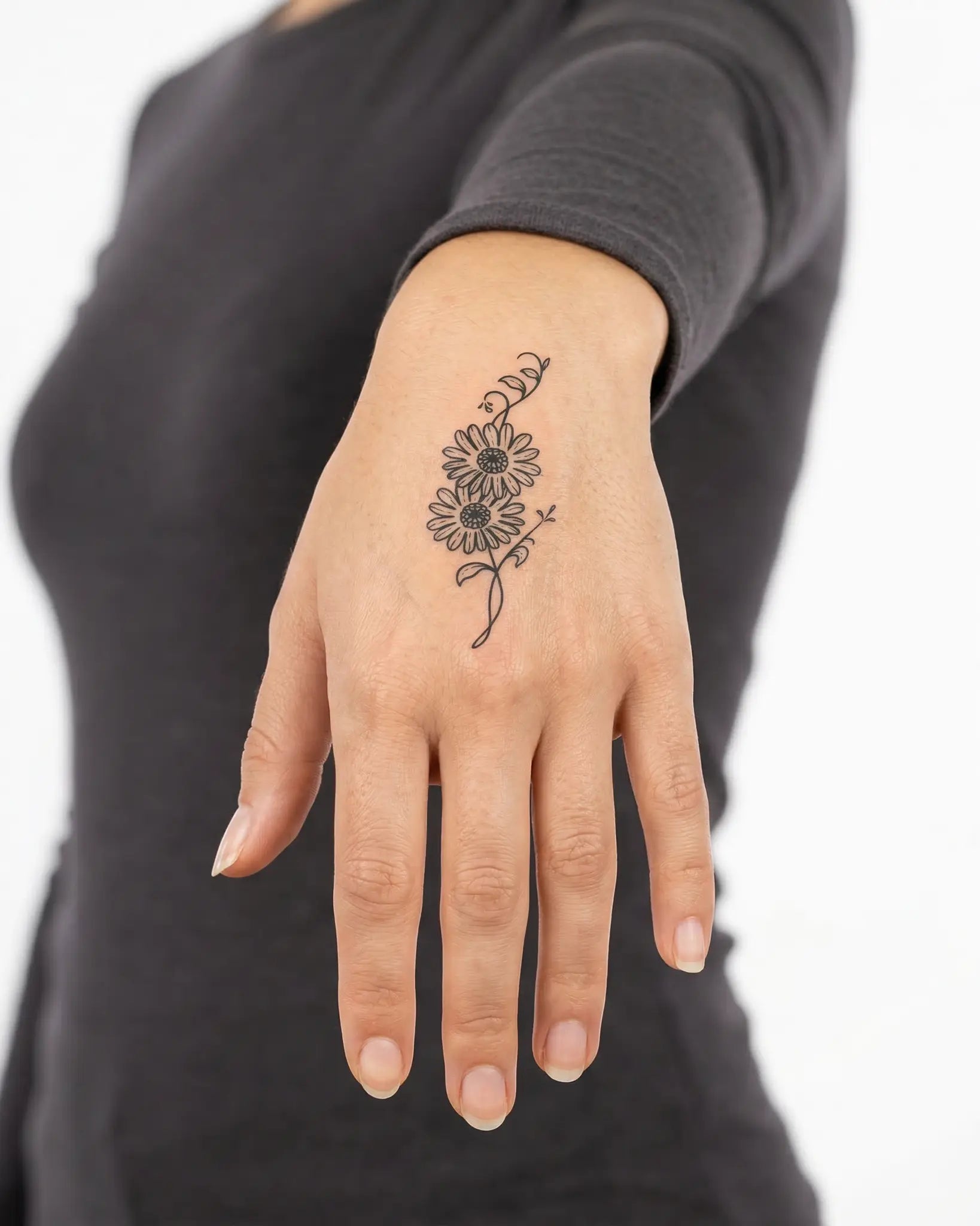 INKY Daisy Duet semi-permanent tattoo applied on a woman – 2 x 2 in (4x4 cm) design, realistic ink look, lasts 10 days