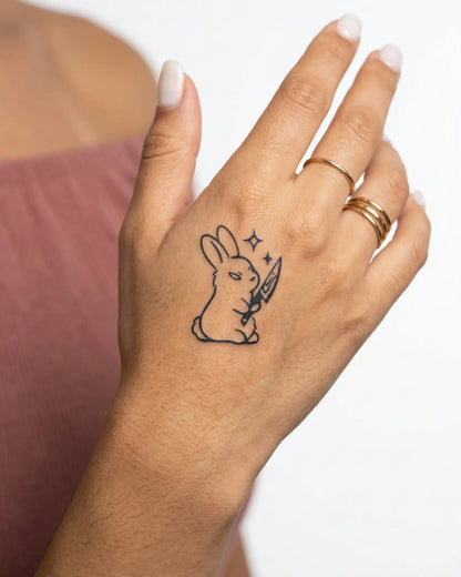 INKY Bunny Knife semi-permanent tattoo applied on a woman – 2 x 2 in (4x4 cm) design, realistic ink look, lasts 10 days