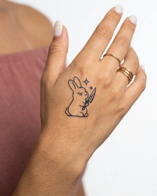 INKY Bunny Knife semi-permanent tattoo applied on a woman – 2 x 2 in (4x4 cm) design, realistic ink look, lasts 10 days
