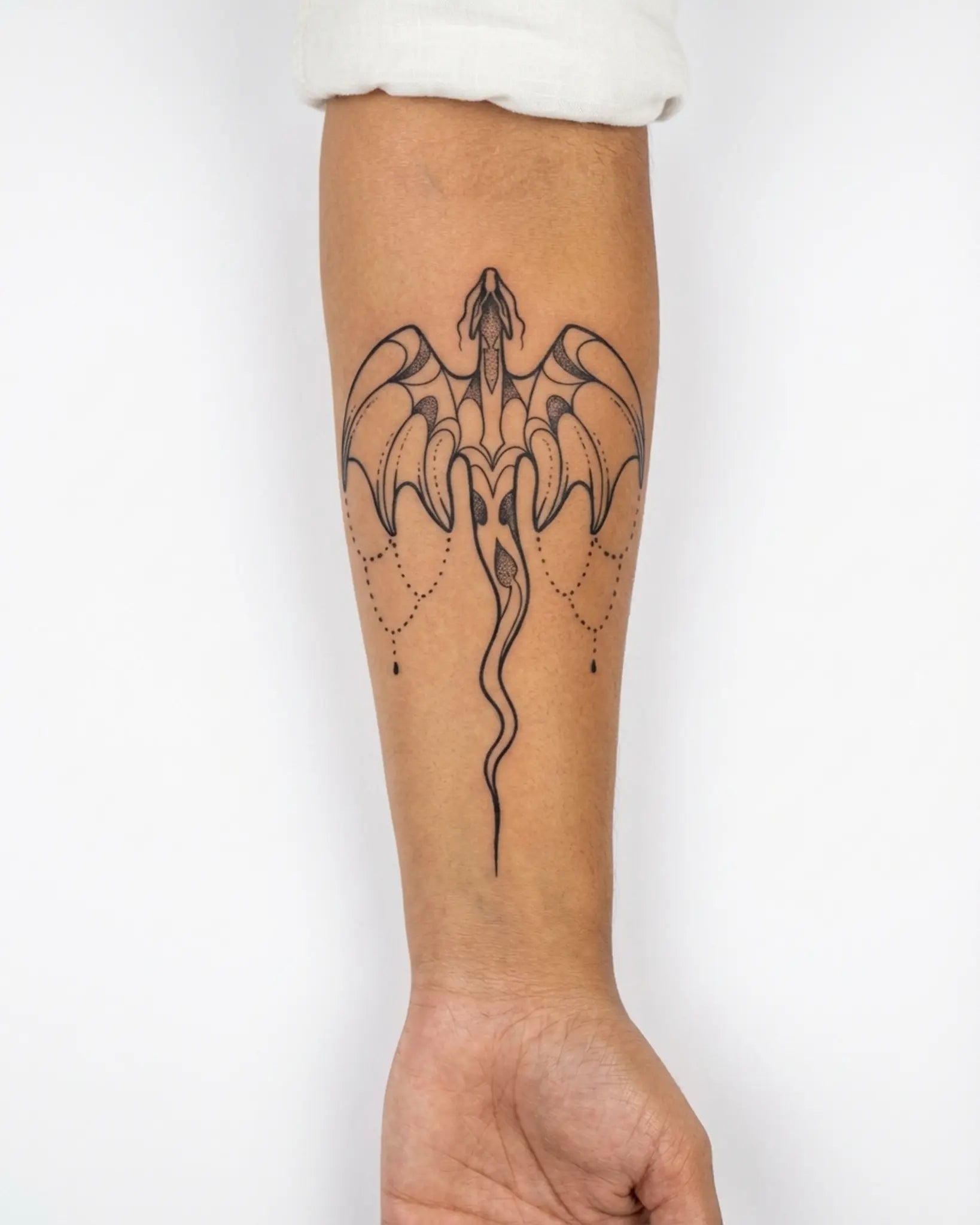 INKY Draco Charm 2 semi-permanent tattoo applied on a woman – 4 x 7 in (10x17 cm) design, realistic ink look, lasts 10 days