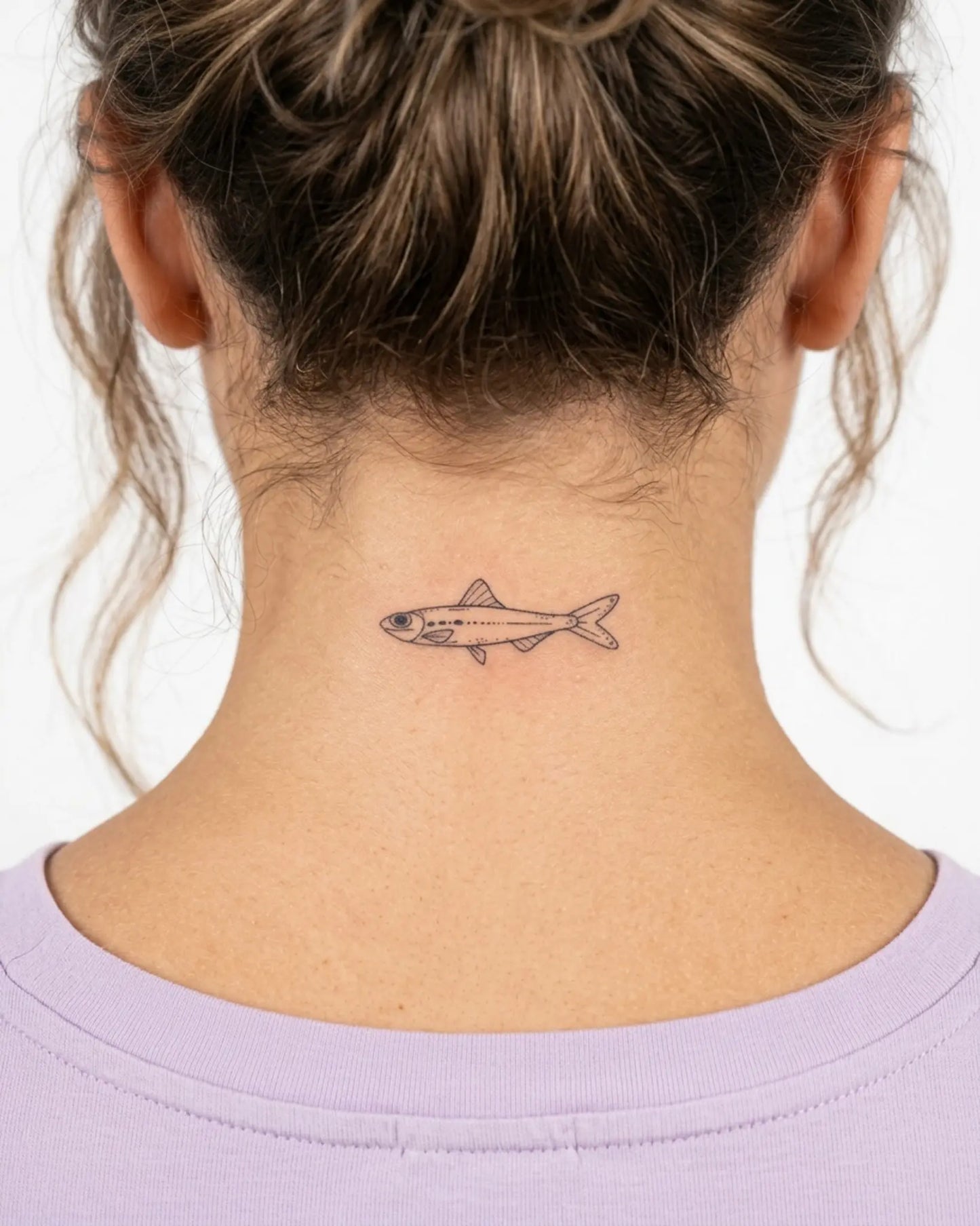 INKY Little Fish 2 semi-permanent tattoo applied on a woman – 2 x 2 in (4x4 cm) design, realistic ink look, lasts 10 days