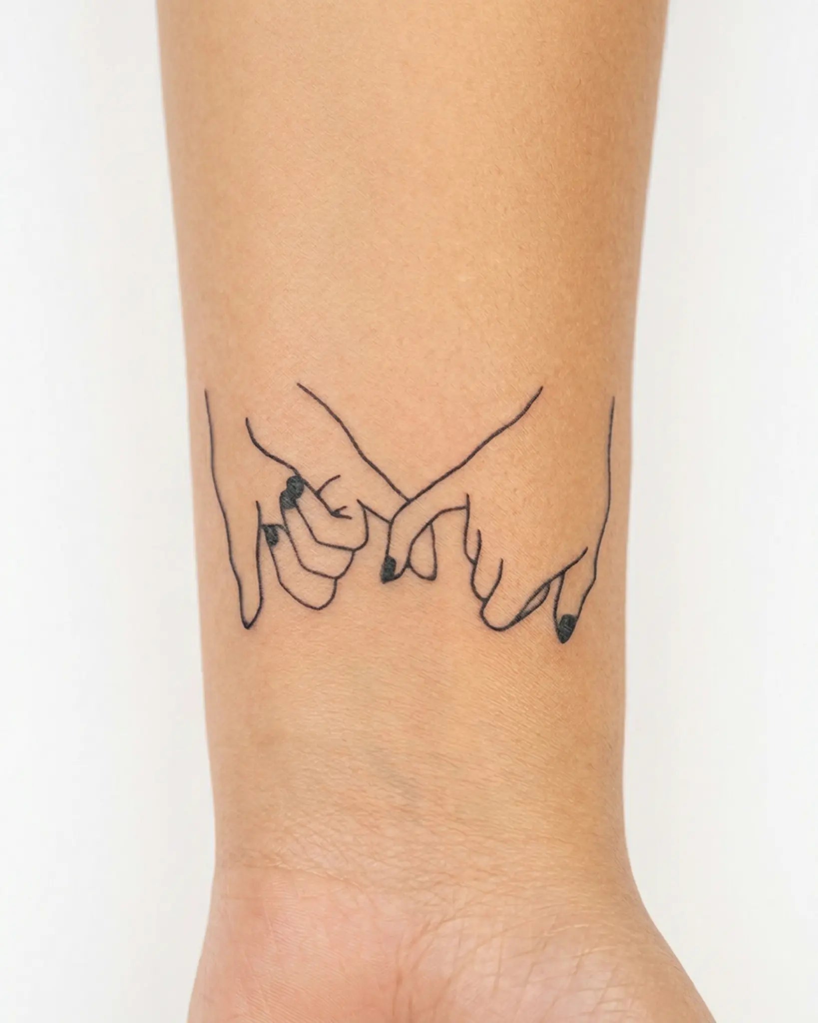 INKY Pinky Promise 2 semi-permanent tattoo applied on a woman – 2 x 2 in (4x4 cm) design, realistic ink look, lasts 10 days