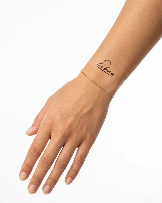 INKY Libra Script semi-permanent tattoo applied on a woman – 2 x 2 in (4x4 cm) design, realistic ink look, lasts 10 days
