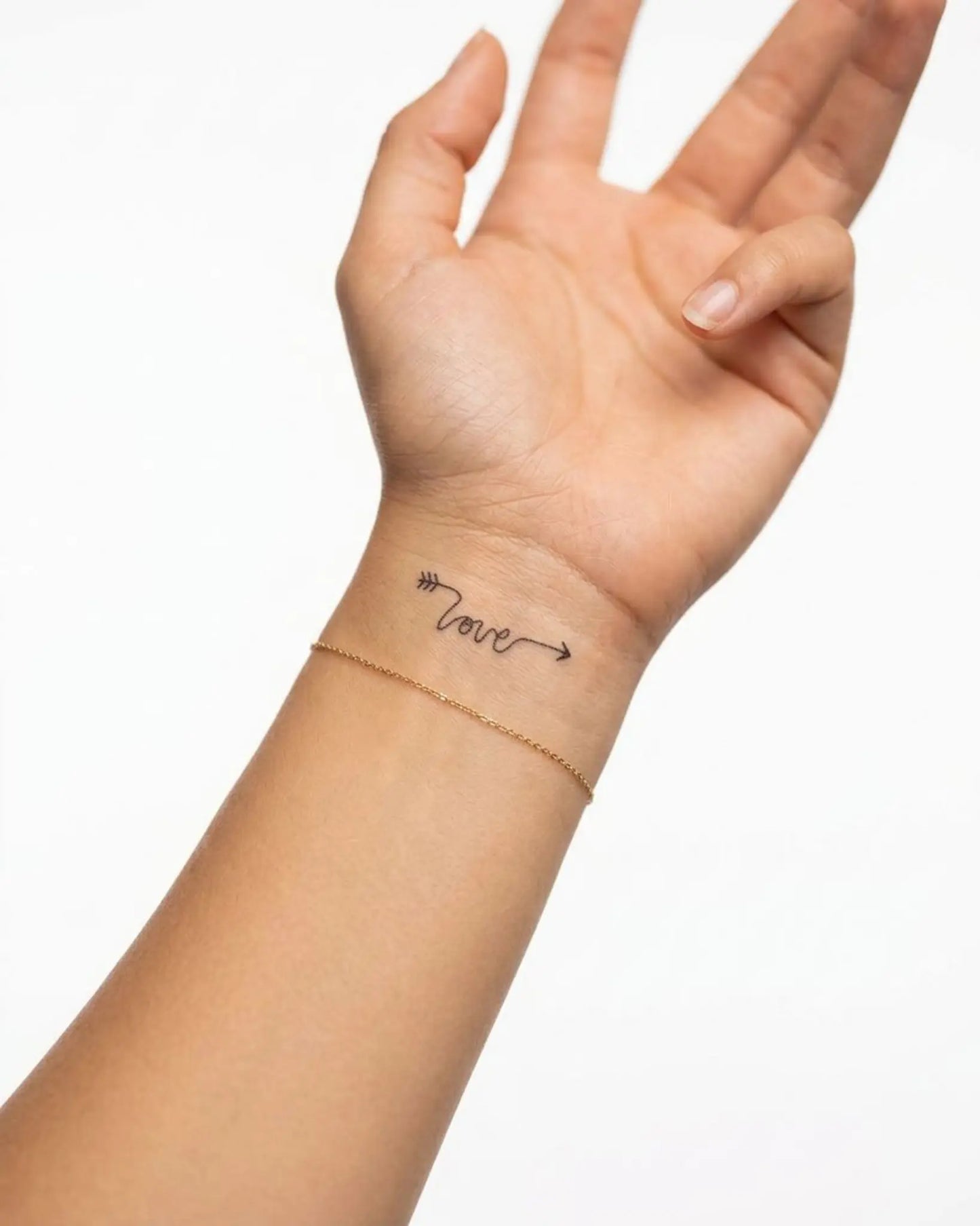 INKY Love Arrow semi-permanent tattoo applied on a woman – 2 x 2 in (4x4 cm) design, realistic ink look, lasts 10 days