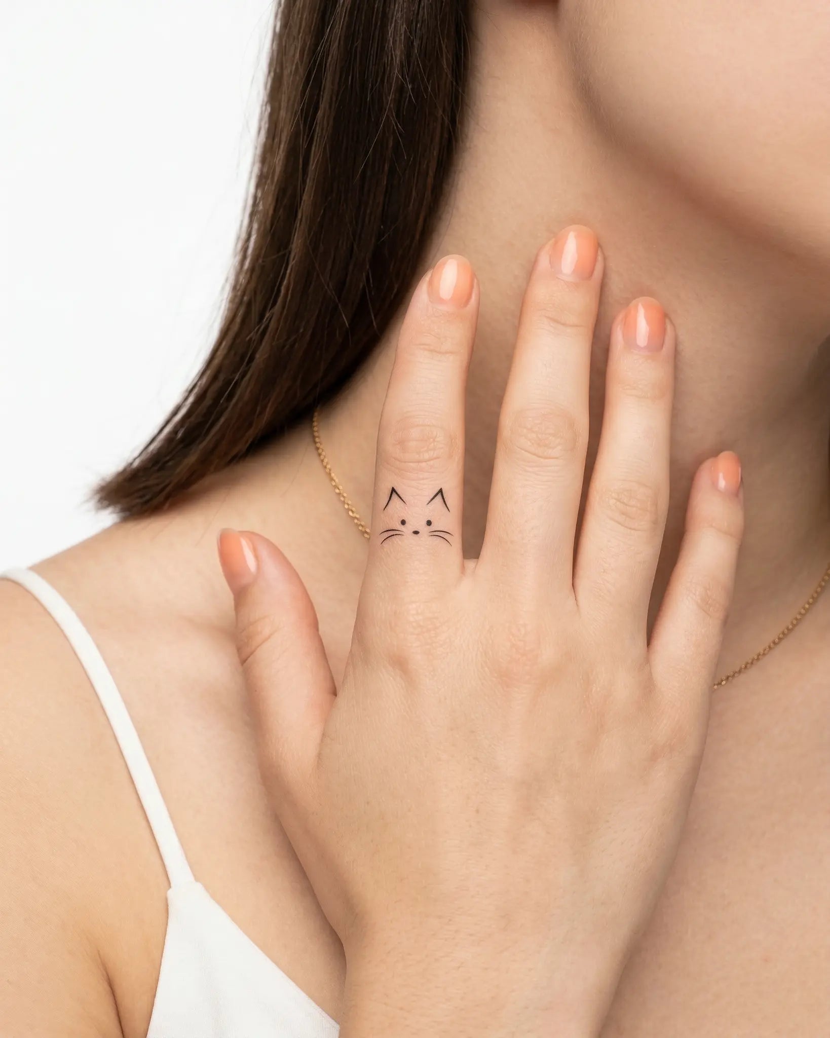 INKY Kitty Face semi-permanent tattoo applied on a woman – 0.5 x 0.5 in (1x1 cm) design, realistic ink look, lasts 10 days