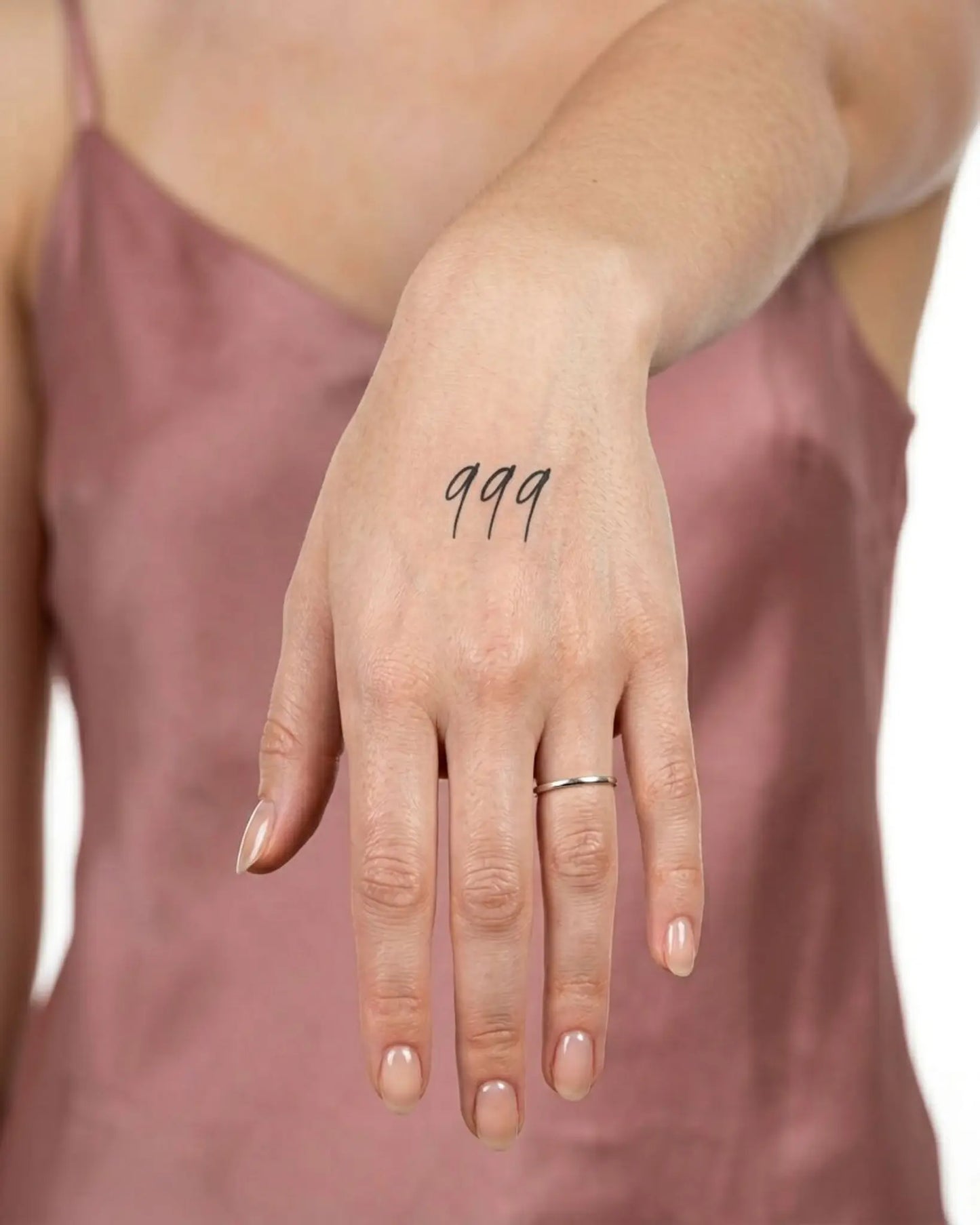 INKY Triple 9 semi-permanent tattoo applied on a woman – 2 x 2 in (4x4 cm) design, realistic ink look, lasts 10 days
