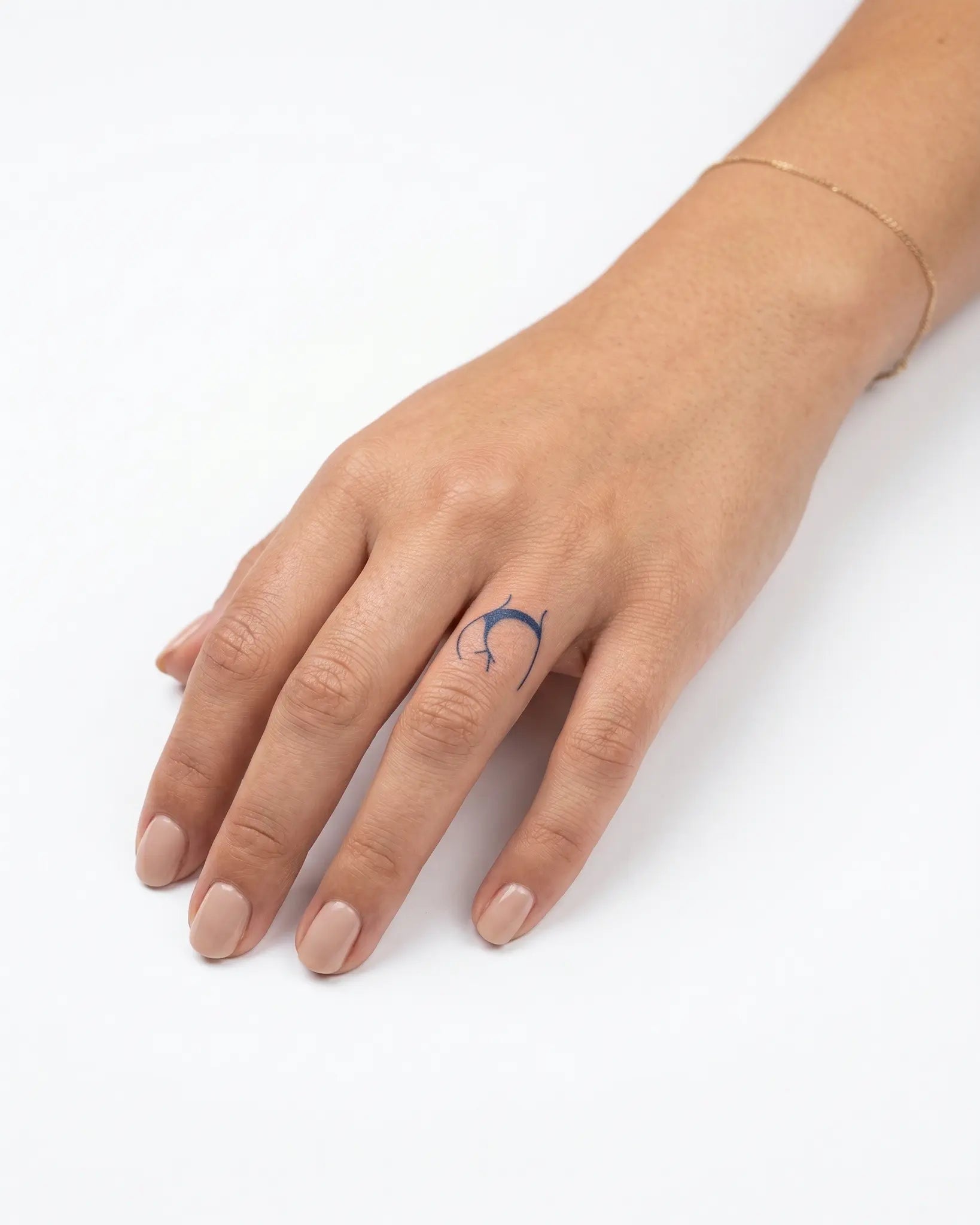 INKY Bum Outline semi-permanent tattoo applied on a woman – 0.5 x 0.5 in (1x1 cm) design, realistic ink look, lasts 10 days
