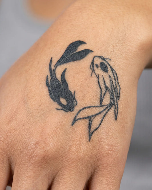 INKY Yin Yang Fish semi-permanent tattoo applied on a woman – 2 x 2 in (4x4 cm) design, realistic ink look, lasts 10 days