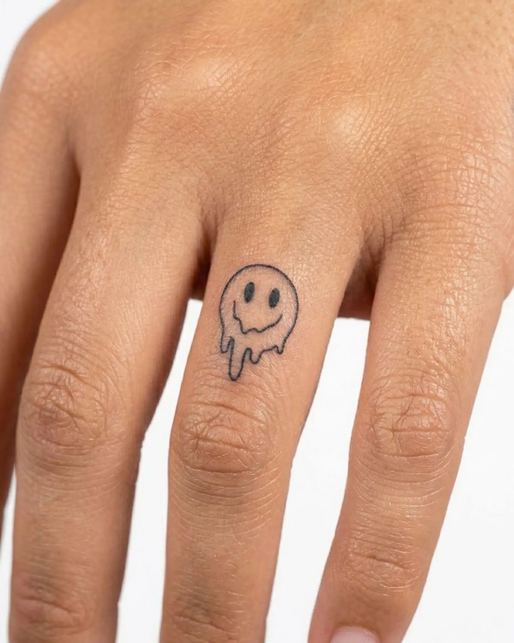 INKY Drippy Smile semi-permanent tattoo applied on a woman – 0.5 x 0.5 in (1x1 cm) design, realistic ink look, lasts 10 days