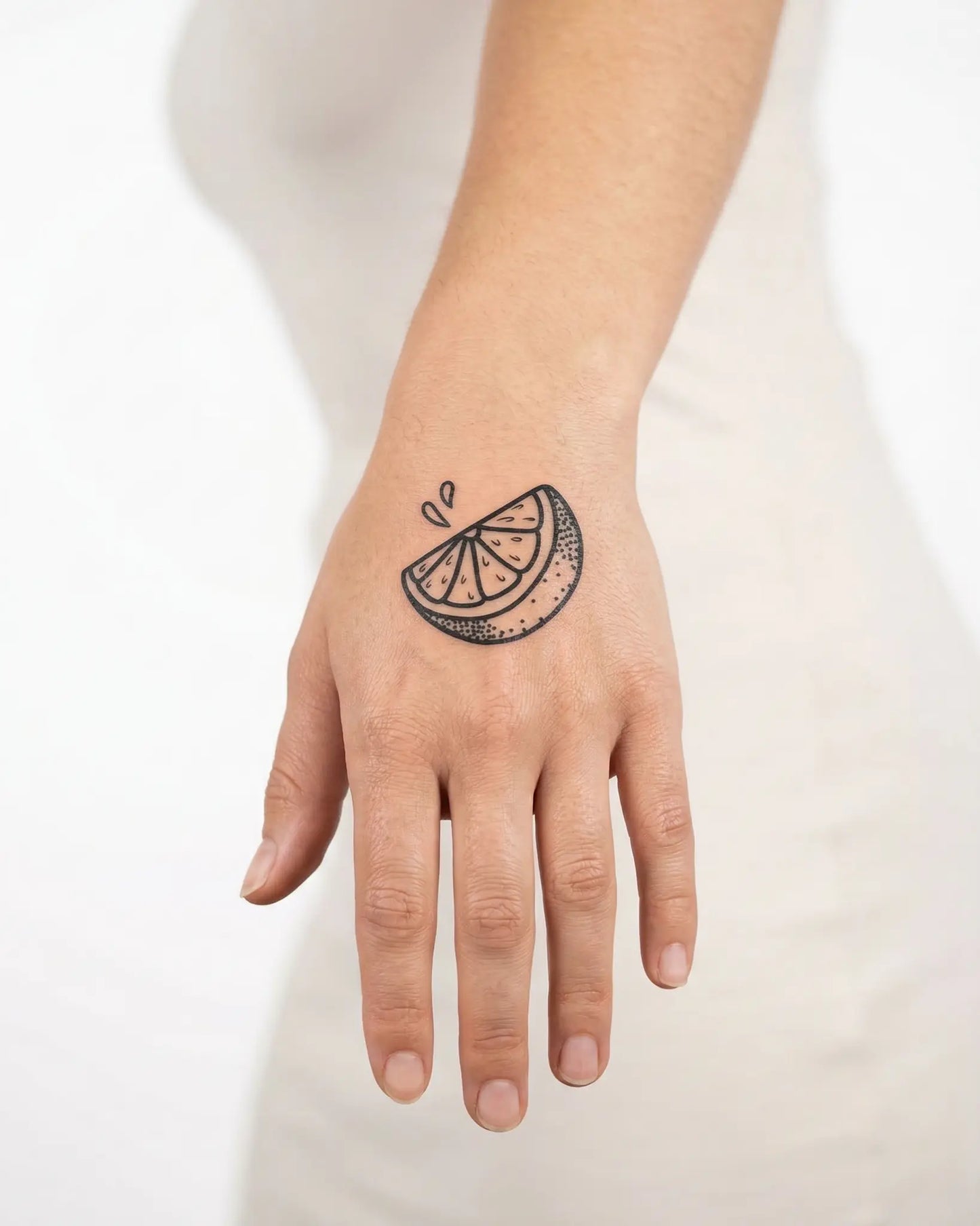 INKY Lemon Zest semi-permanent tattoo applied on a woman – 2 x 2 in (4x4 cm) design, realistic ink look, lasts 10 days