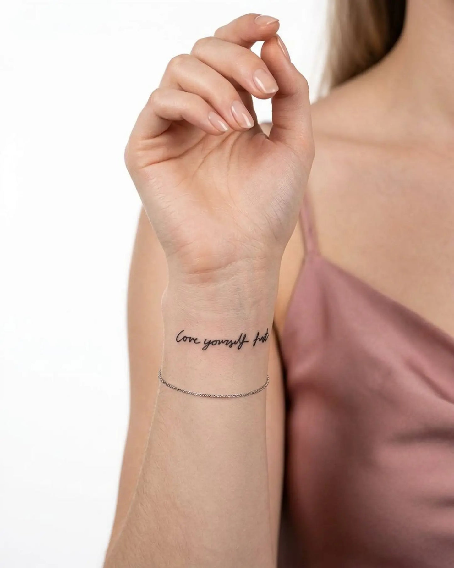 INKY Love First semi-permanent tattoo applied on a woman – 2 x 2 in (4x4 cm) design, realistic ink look, lasts 10 days