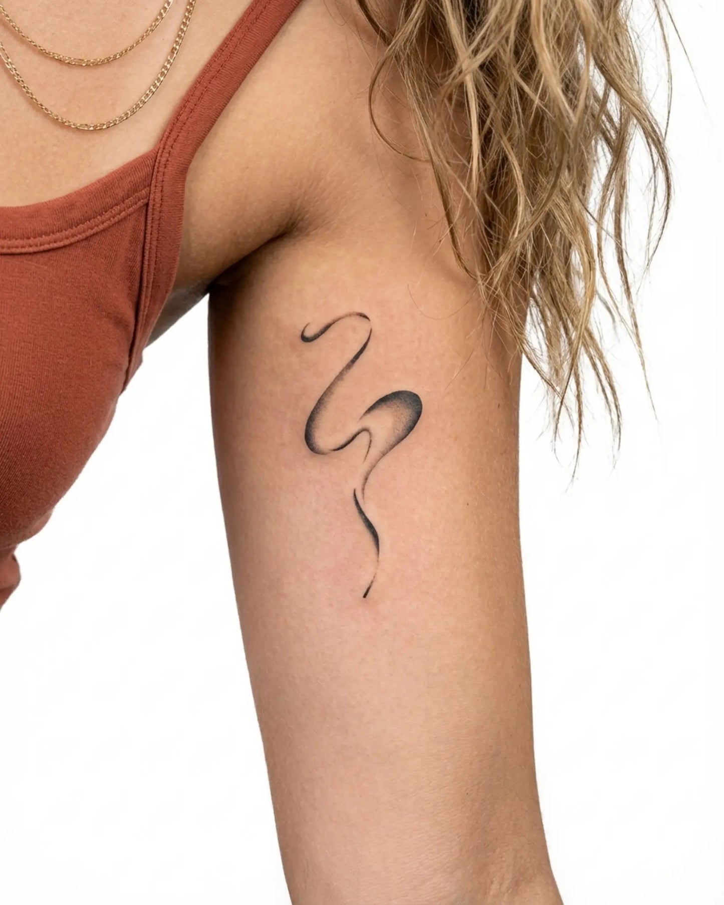 INKY Flow Line 2 semi-permanent tattoo applied on a woman – 2 x 4 in (6x10 cm) design, realistic ink look, lasts 10 days