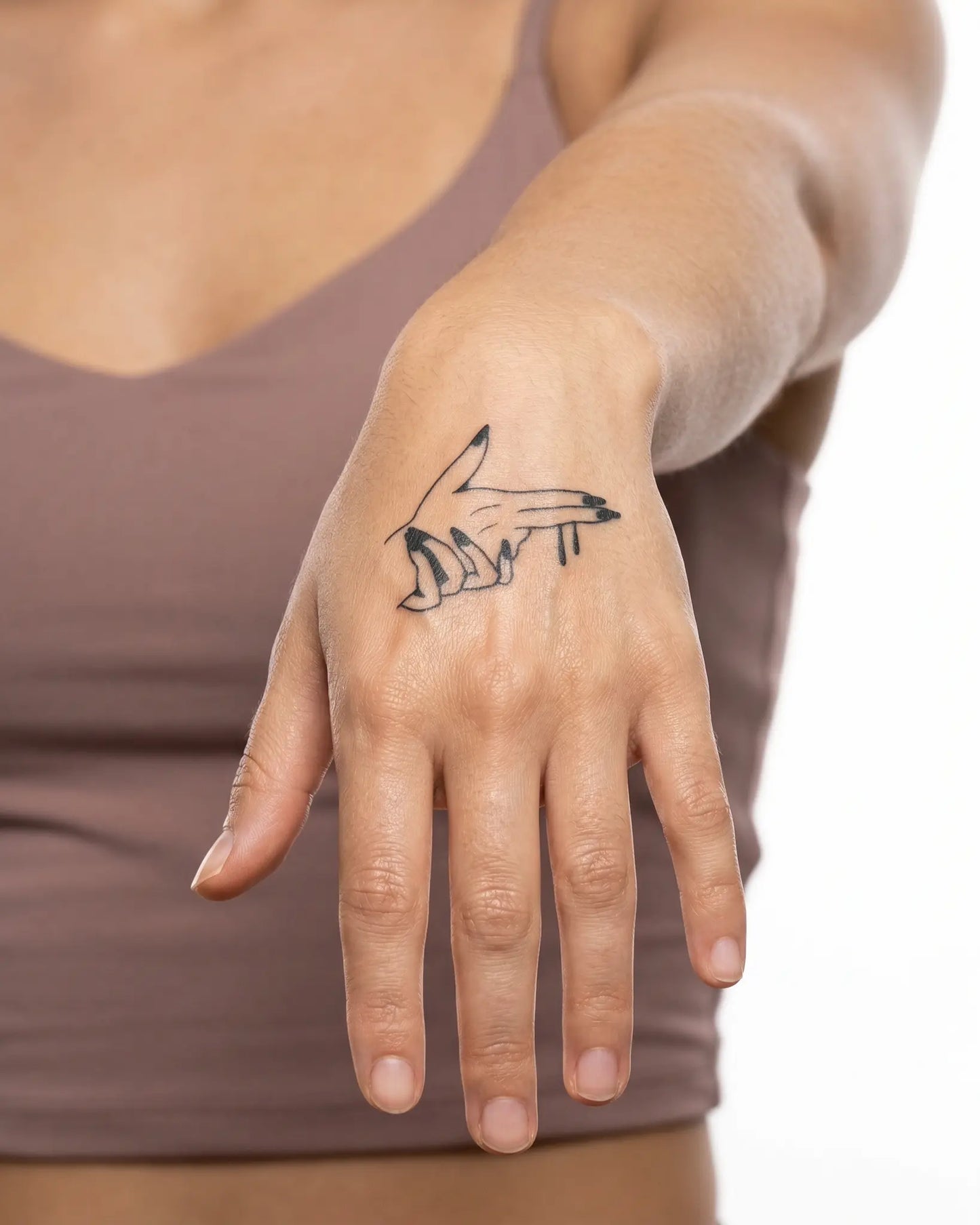 INKY Bang Bang semi-permanent tattoo applied on a woman – 2 x 2 in (4x4 cm) design, realistic ink look, lasts 10 days