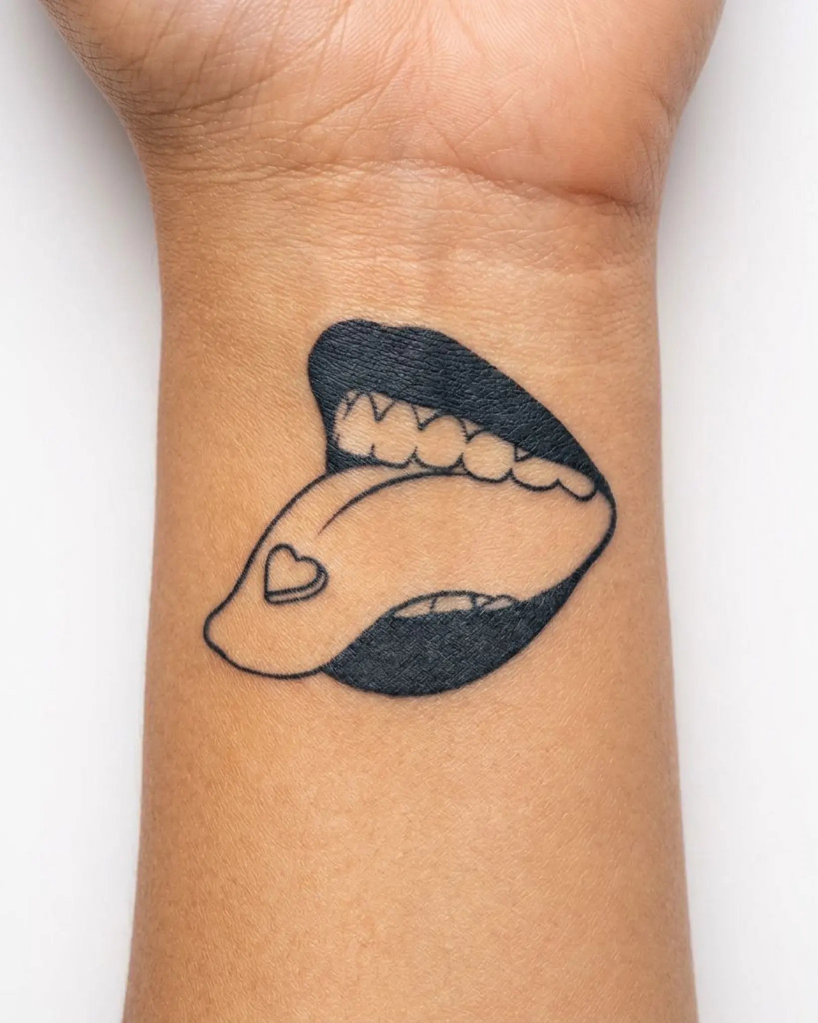 INKY Sweet Lick semi-permanent tattoo applied on a woman – 2 x 2 in (4x4 cm) design, realistic ink look, lasts 10 days