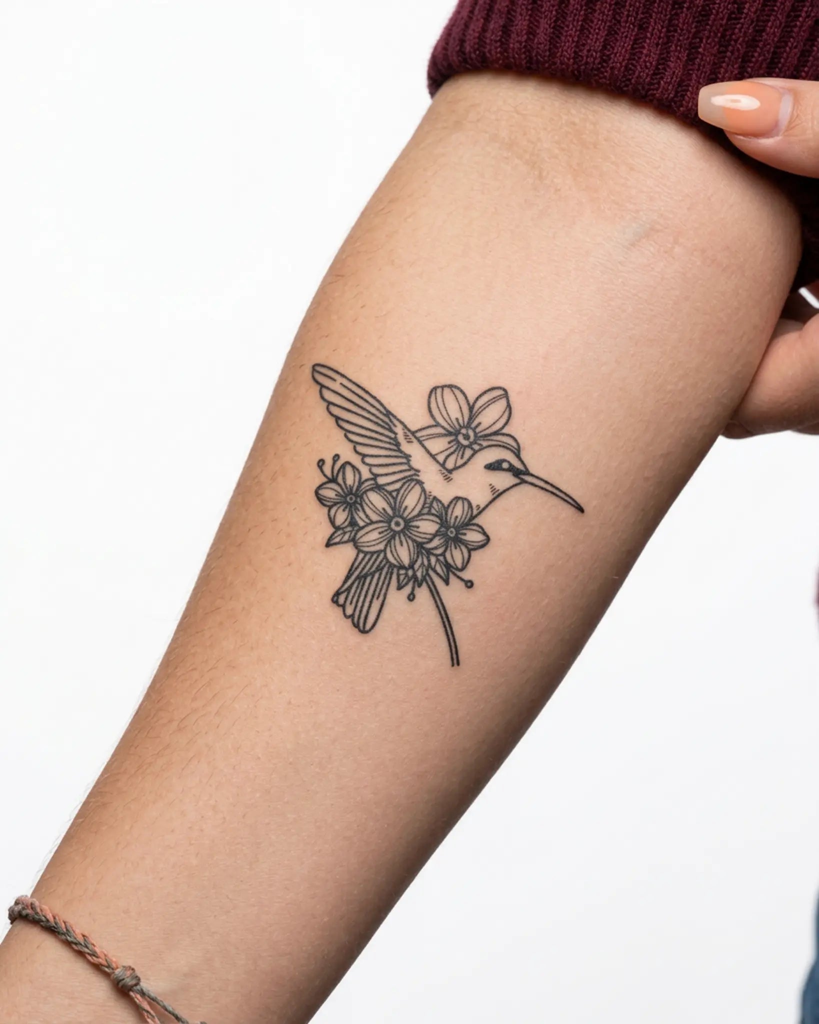 INKY Humming Bloom semi-permanent tattoo applied on a woman – 3 x 3 in (7x7 cm) design, realistic ink look, lasts 10 days
