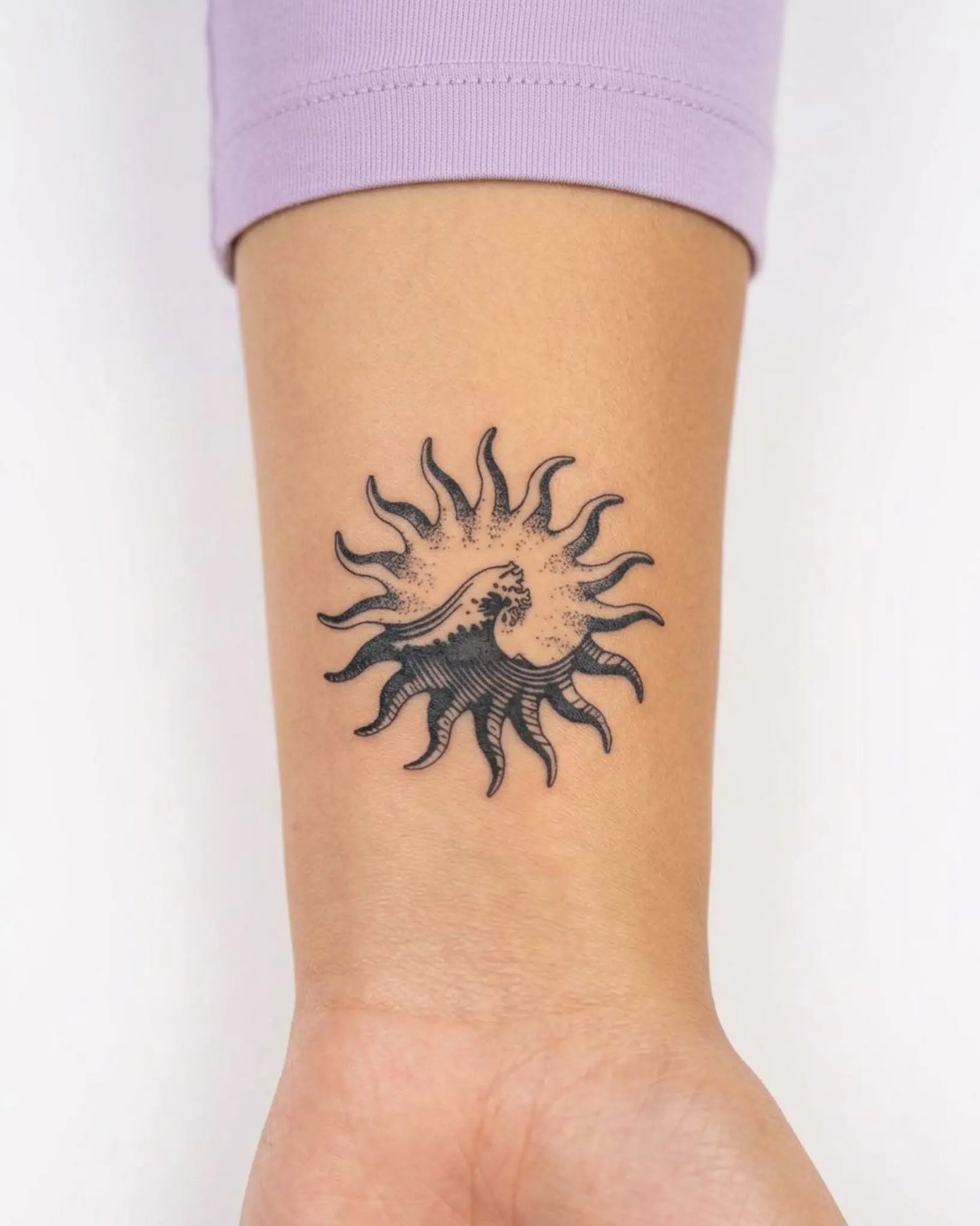 INKY Solar Wave semi-permanent tattoo applied on a woman – 2 x 2 in (4x4 cm) design, realistic ink look, lasts 10 days