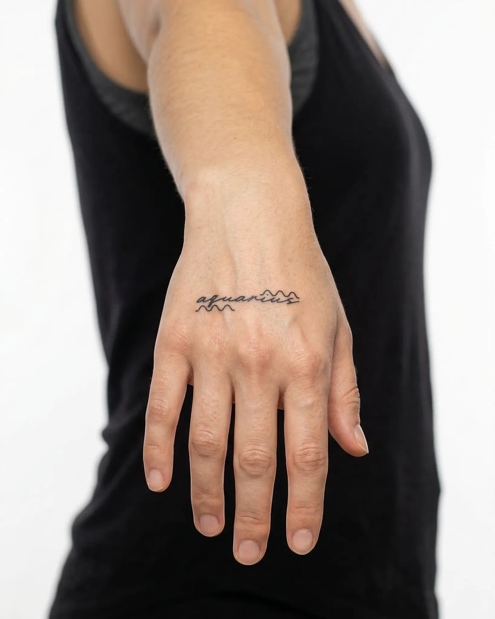 INKY Aquarius Tat semi-permanent tattoo applied on a woman – 2 x 2 in (4x4 cm) design, realistic ink look, lasts 10 days