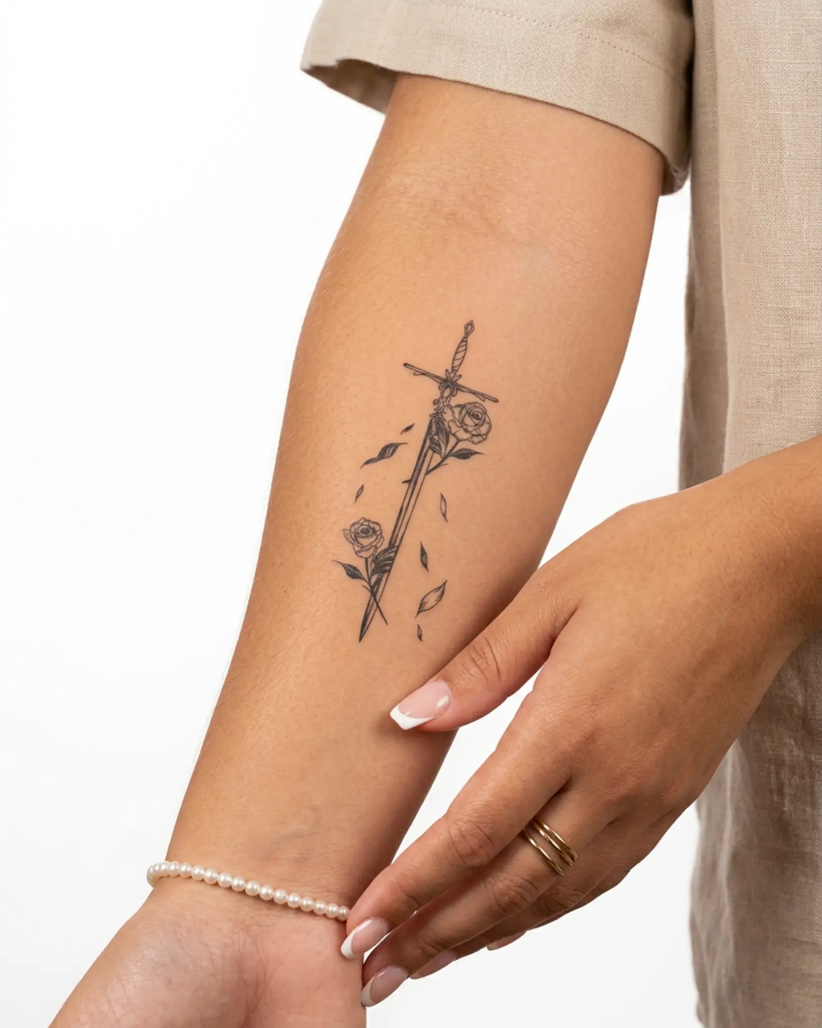 INKY Rose Sword semi-permanent tattoo applied on a woman – 2 x 4 in (6x10 cm) design, realistic ink look, lasts 10 days