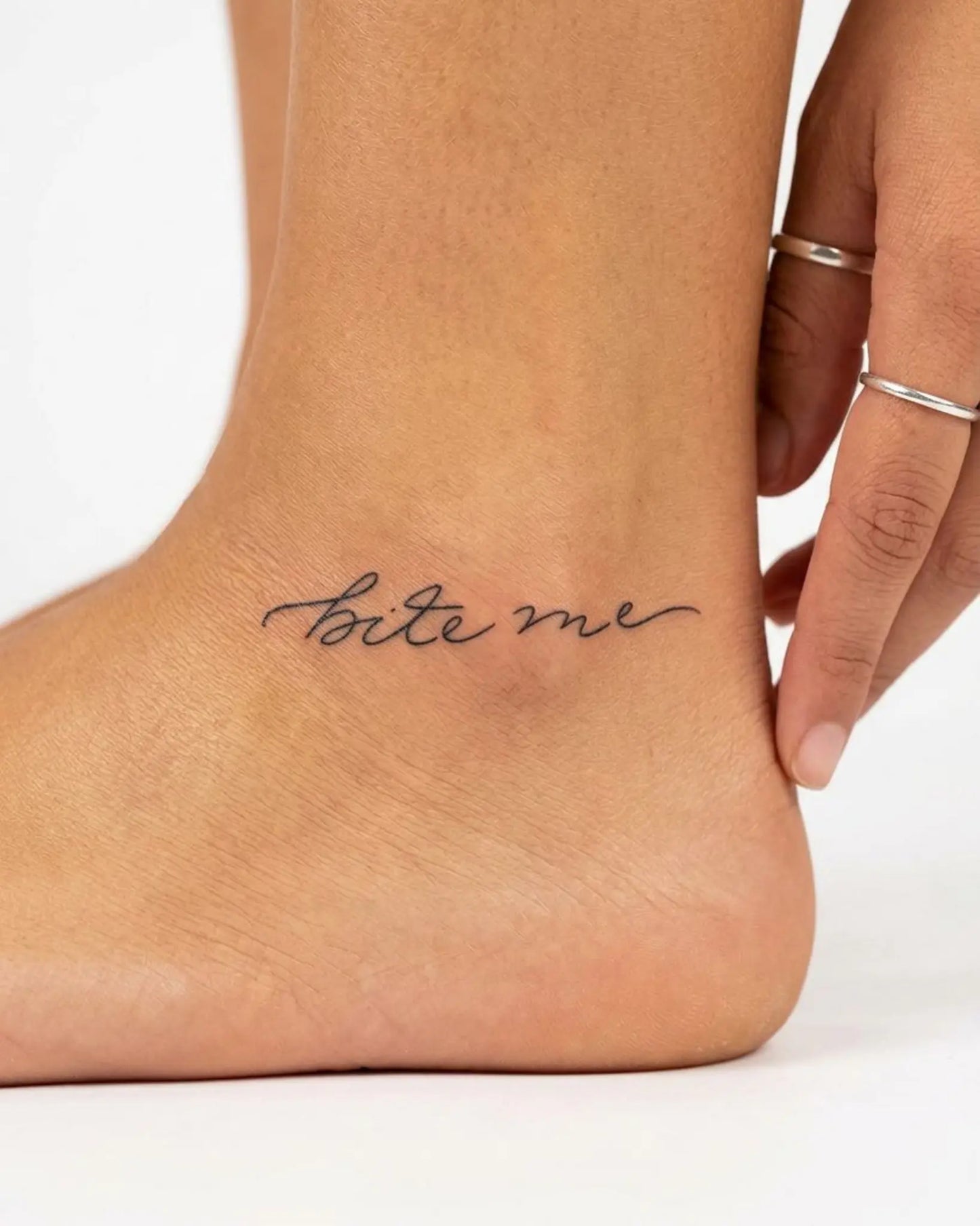 INKY Bite Me semi-permanent tattoo applied on a woman – 2 x 2 in (4x4 cm) design, realistic ink look, lasts 10 days