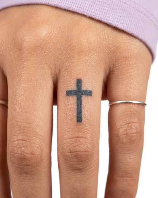 INKY Minimal Cross semi-permanent tattoo applied on a woman – 0.5 x 0.5 in (1x1 cm) design, realistic ink look, lasts 10 days
