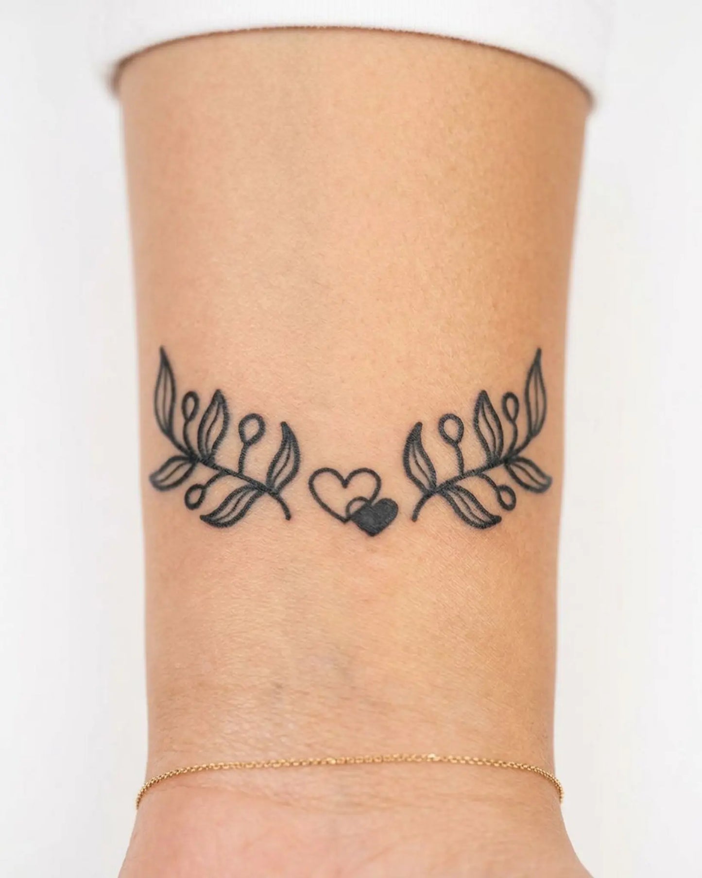 INKY Leafy Hearts semi-permanent tattoo applied on a woman – 2 x 2 in (4x4 cm) design, realistic ink look, lasts 10 days