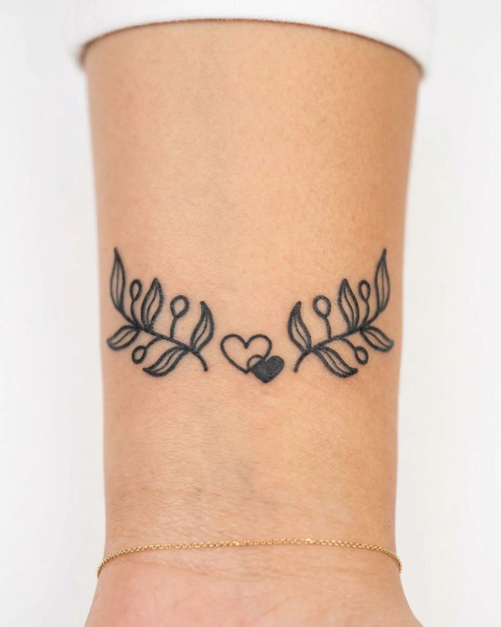 INKY Leafy Hearts semi-permanent tattoo applied on a woman – 2 x 2 in (4x4 cm) design, realistic ink look, lasts 10 days