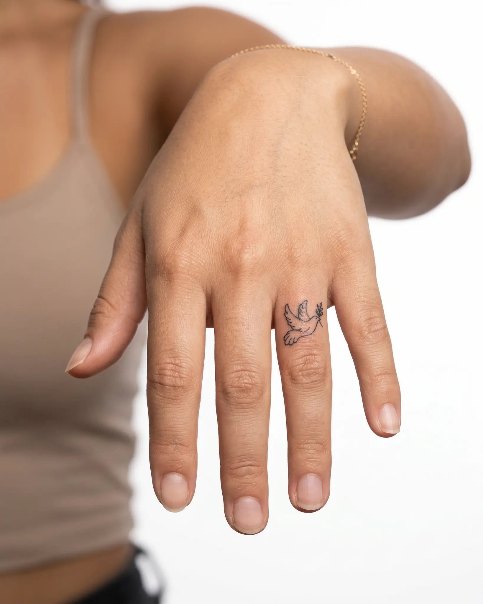 INKY Peace Dove semi-permanent tattoo applied on a woman – 0.5 x 0.5 in (1x1 cm) design, realistic ink look, lasts 10 days