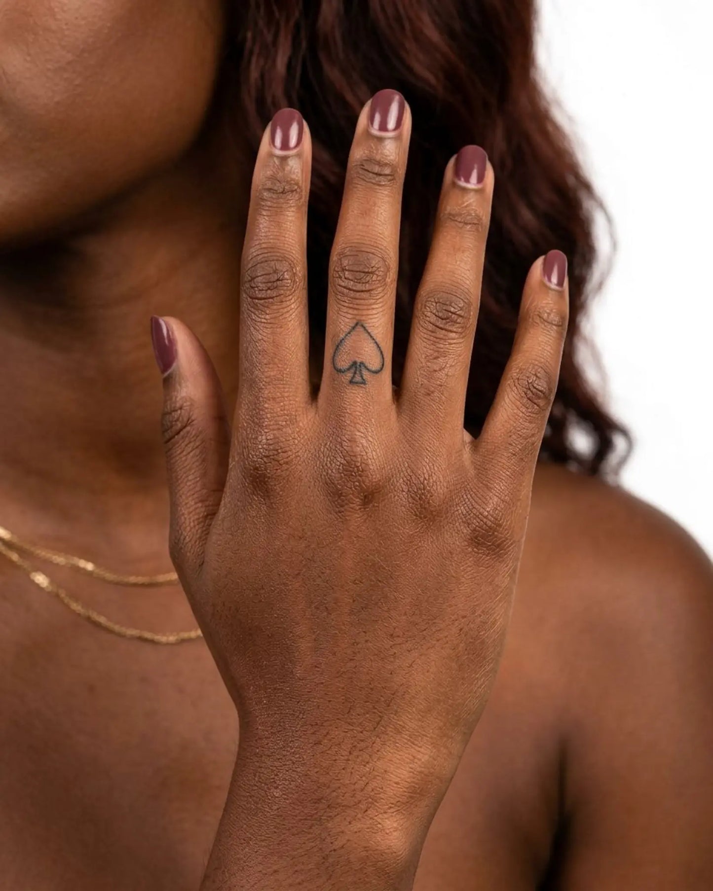 INKY Black Spade semi-permanent tattoo applied on a woman – 0.5 x 0.5 in (1x1 cm) design, realistic ink look, lasts 10 days