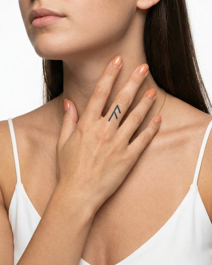 INKY Fehu Rune 2 semi-permanent tattoo applied on a woman – 0.5 x 0.5 in (1x1 cm) design, realistic ink look, lasts 10 days