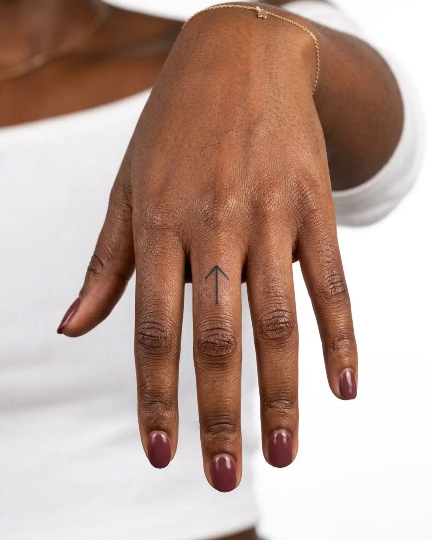 INKY Arrow Up semi-permanent tattoo applied on a woman – 0.5 x 0.5 in (1x1 cm) design, realistic ink look, lasts 10 days