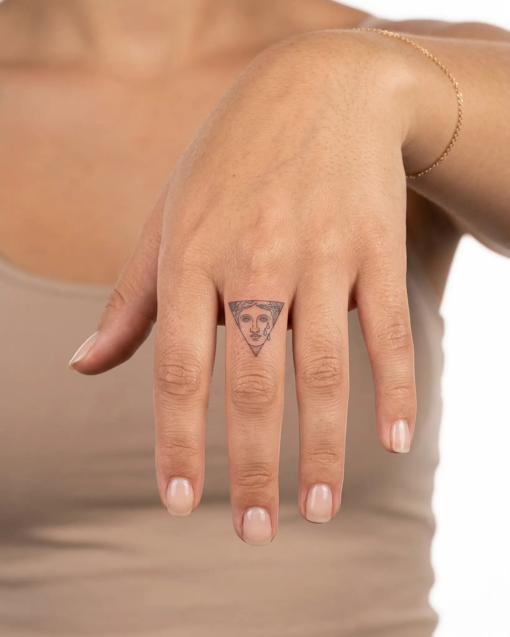 INKY Crying Muse semi-permanent tattoo applied on a woman – 0.5 x 0.5 in (1x1 cm) design, realistic ink look, lasts 10 days