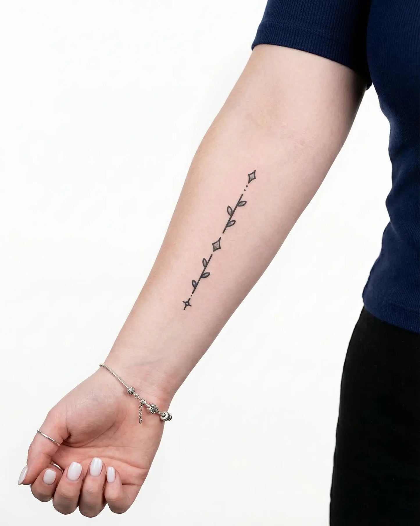 INKY Star Stem semi-permanent tattoo applied on a woman – 2 x 4 in (6x10 cm) design, realistic ink look, lasts 10 days