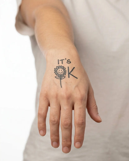 INKY It's OK semi-permanent tattoo applied on a woman – 2 x 2 in (4x4 cm) design, realistic ink look, lasts 10 days